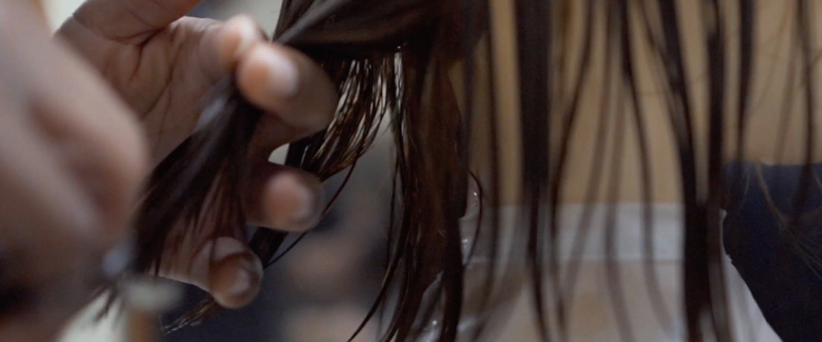 Students cutting hair in cosmetology class